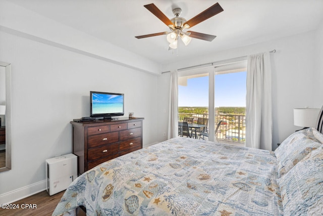 bedroom featuring ceiling fan, dark hardwood / wood-style floors, and access to outside