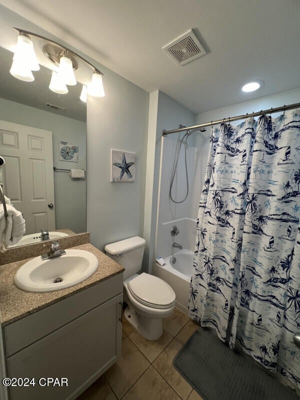 full bathroom featuring shower / tub combo with curtain, vanity, toilet, and tile patterned flooring