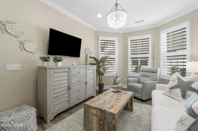 living room featuring a chandelier, ornamental molding, and dark wood-type flooring