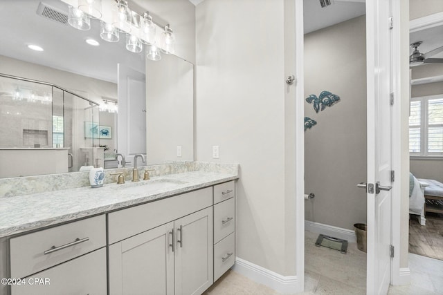 bathroom with tile patterned floors, vanity, and a shower with door