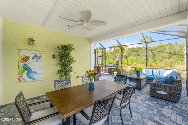 sunroom / solarium featuring ceiling fan and wood ceiling