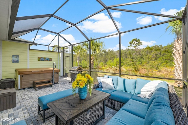 view of patio with an outdoor living space, a hot tub, grilling area, and a lanai