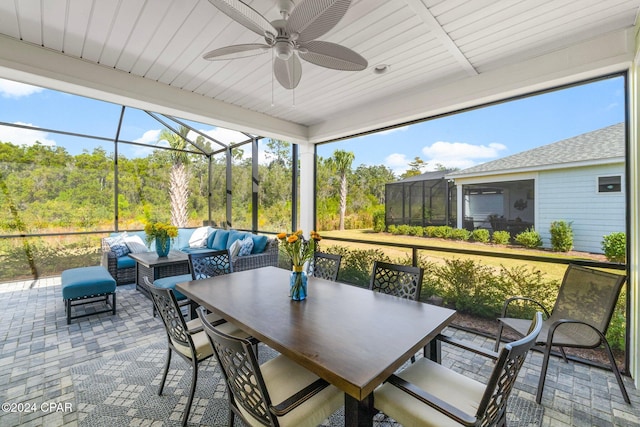 sunroom with ceiling fan and wood ceiling