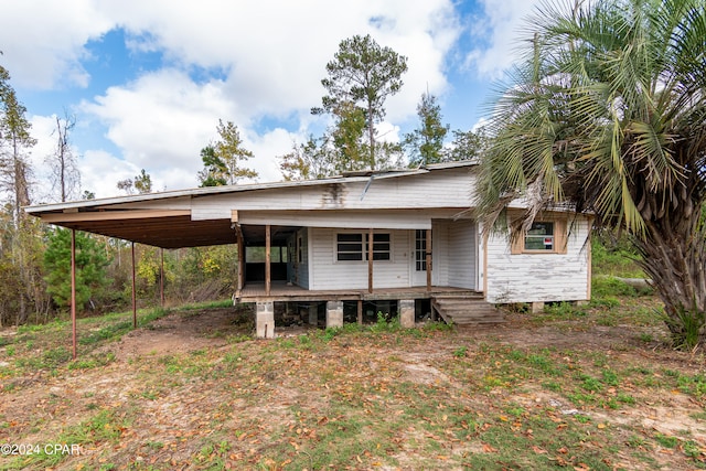 rear view of house with a carport and covered porch