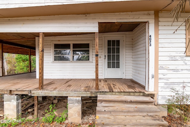 view of exterior entry with a deck