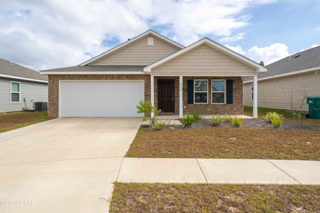 view of front of home featuring cooling unit and a garage