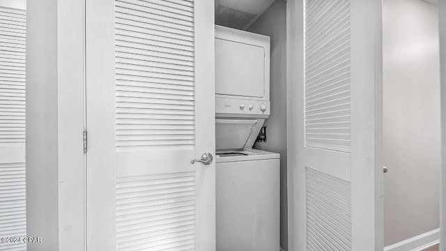 laundry area featuring stacked washer and clothes dryer