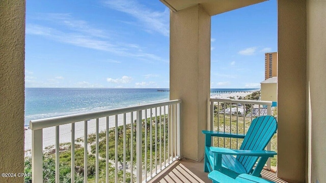 balcony with a view of the beach and a water view