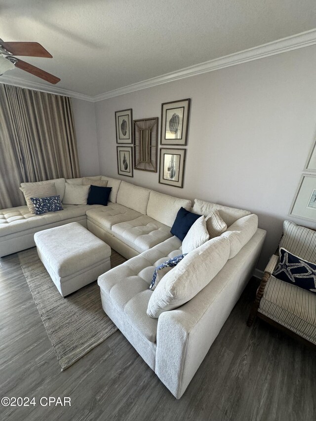 living room with crown molding, ceiling fan, a textured ceiling, and dark hardwood / wood-style flooring