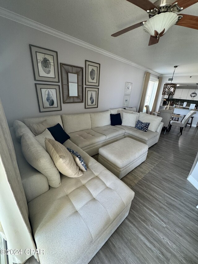 living room featuring ceiling fan, crown molding, and hardwood / wood-style floors