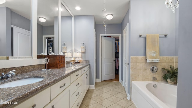 bathroom featuring vanity, a tub to relax in, and tile patterned floors