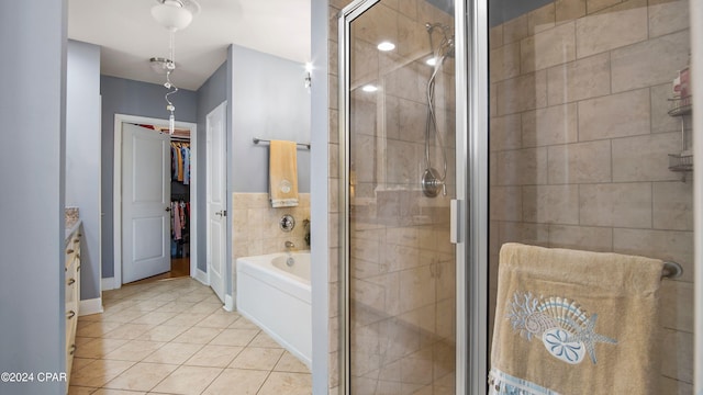 8700 Front Beach Rd Unit 4216, Panama City Beach, FL 32407 - bathroom featuring a stall shower, tile patterned flooring, a bath, a walk in closet, and vanity