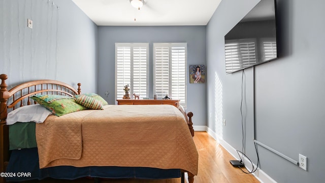 bedroom featuring hardwood / wood-style flooring and ceiling fan