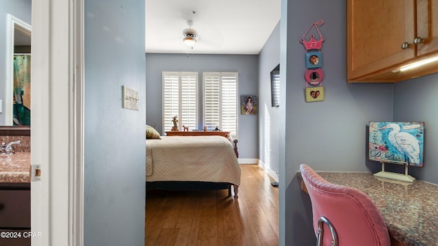 bedroom with light wood-type flooring and ceiling fan