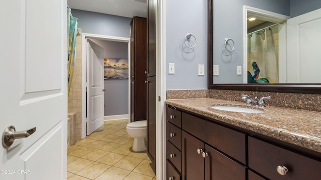 bathroom with toilet, curtained shower, vanity, and tile patterned floors