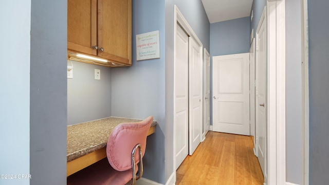 hallway with light hardwood / wood-style floors