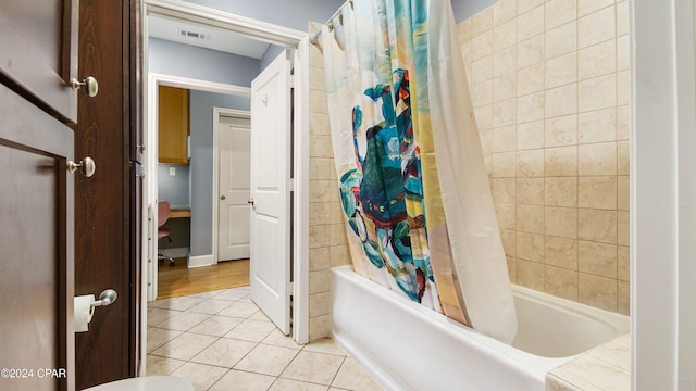 bathroom with tile patterned floors and shower / tub combo