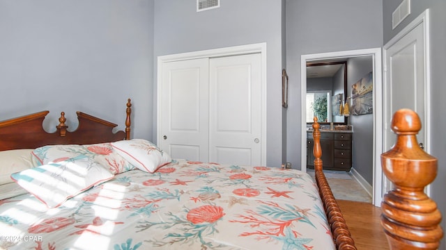 bedroom with a closet and light hardwood / wood-style flooring