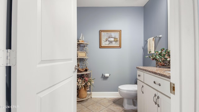 bathroom featuring vanity, tile patterned flooring, and toilet