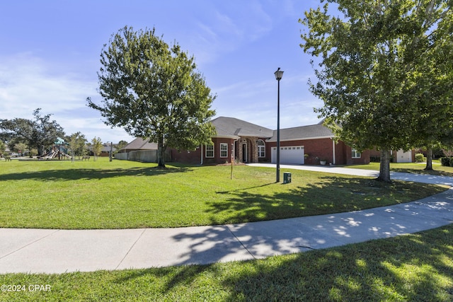 ranch-style home featuring a playground, a front lawn, and a garage