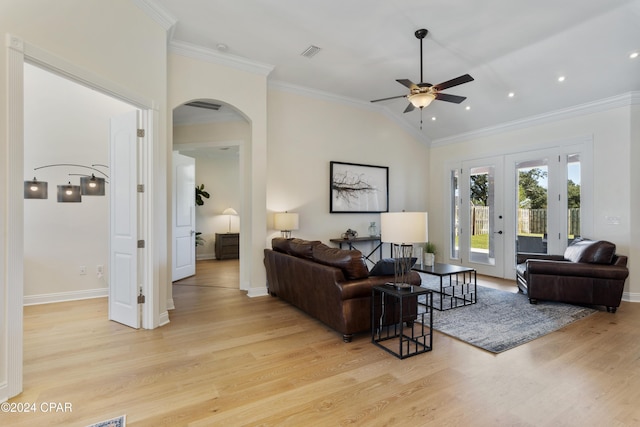 living room with french doors, crown molding, vaulted ceiling, light hardwood / wood-style flooring, and ceiling fan