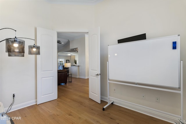 interior space with wood-type flooring and ornamental molding