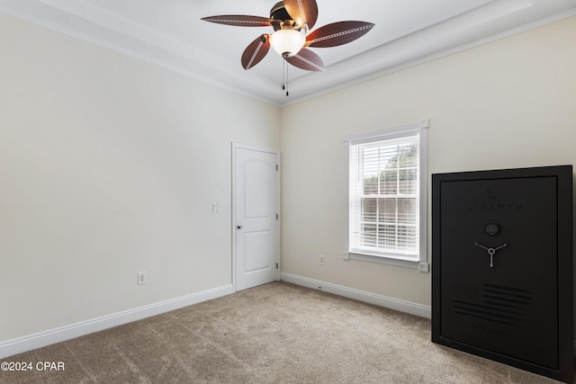 unfurnished room featuring ceiling fan, crown molding, and light carpet