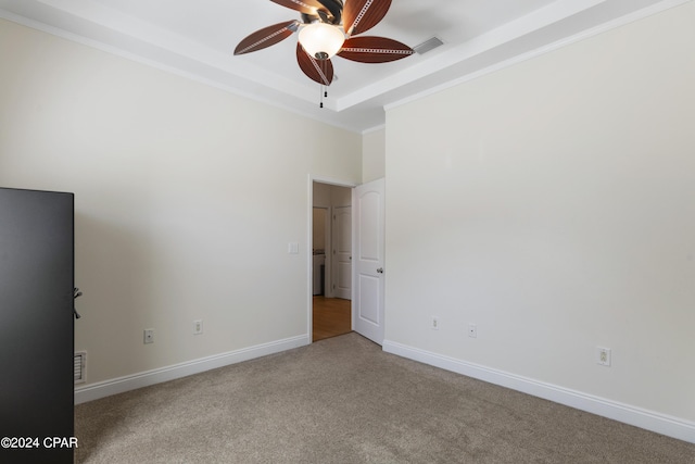 carpeted spare room with ceiling fan and crown molding