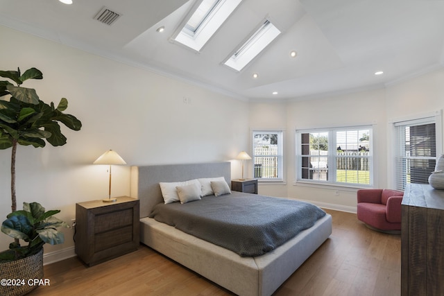 bedroom featuring wood-type flooring, high vaulted ceiling, and ornamental molding