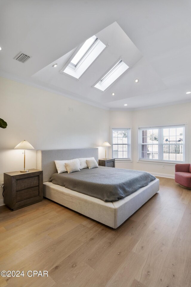 bedroom featuring ornamental molding and light wood-type flooring