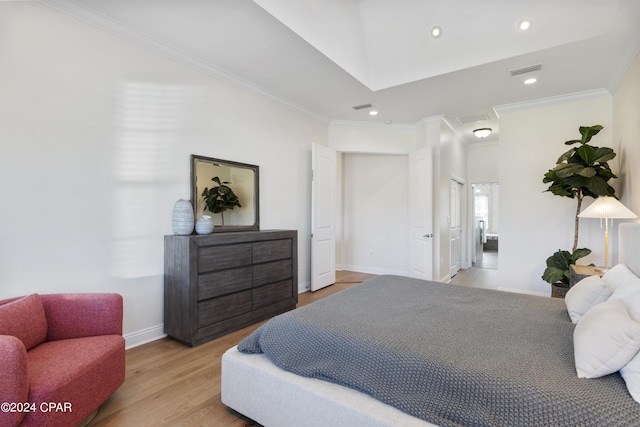 bedroom with crown molding and light hardwood / wood-style flooring