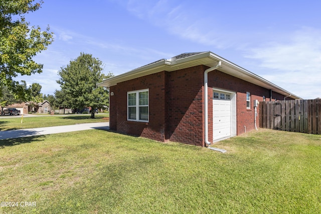 view of side of property with a yard and a garage