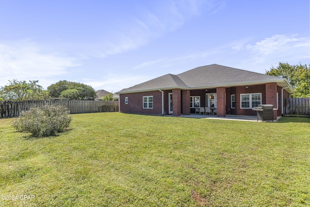 back of property featuring a patio area and a yard