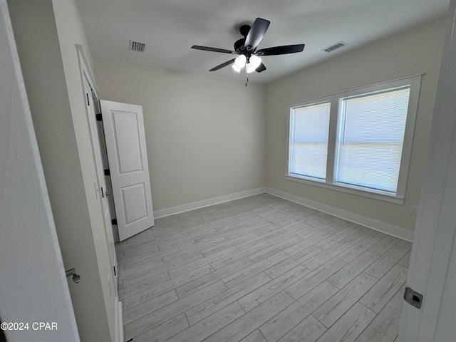 empty room featuring light wood-type flooring and ceiling fan