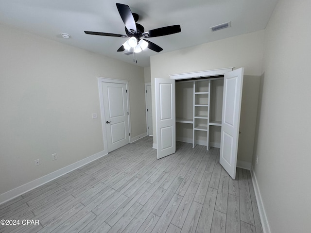 unfurnished bedroom with light hardwood / wood-style floors, a closet, and ceiling fan