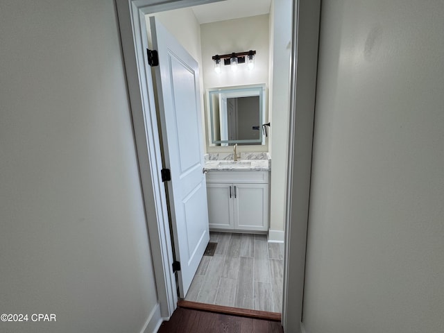 bathroom with vanity and wood-type flooring