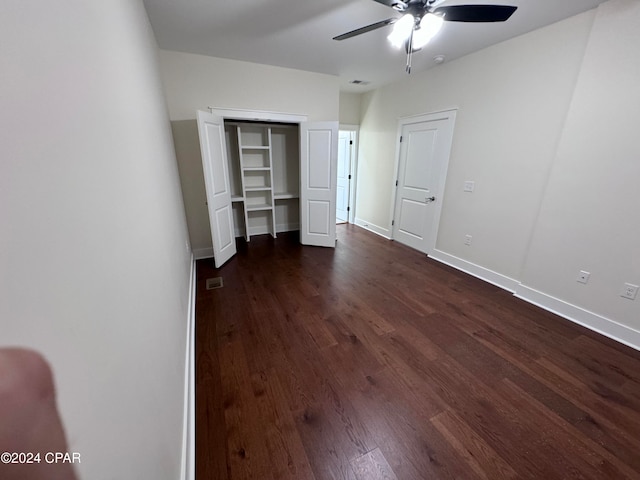 unfurnished bedroom with dark hardwood / wood-style floors and ceiling fan