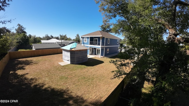 rear view of house with a yard and a patio area