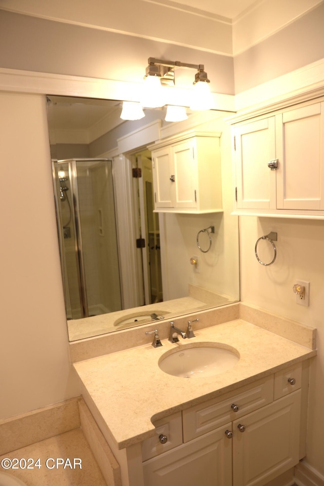 bathroom featuring vanity and a shower with shower door