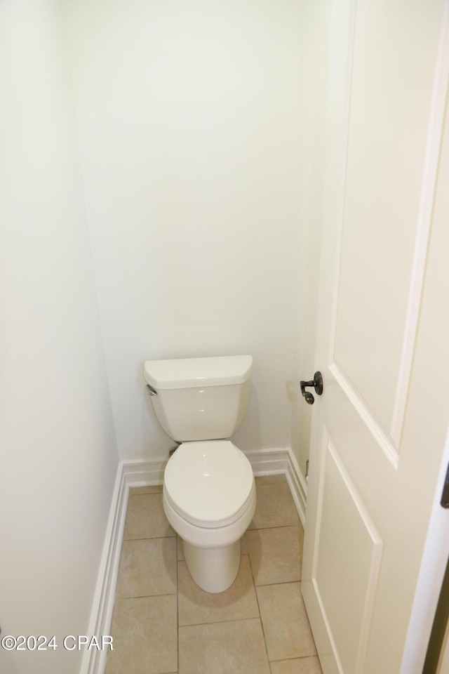 bathroom featuring tile patterned flooring and toilet