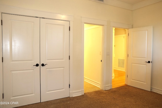 unfurnished bedroom with carpet floors and a closet