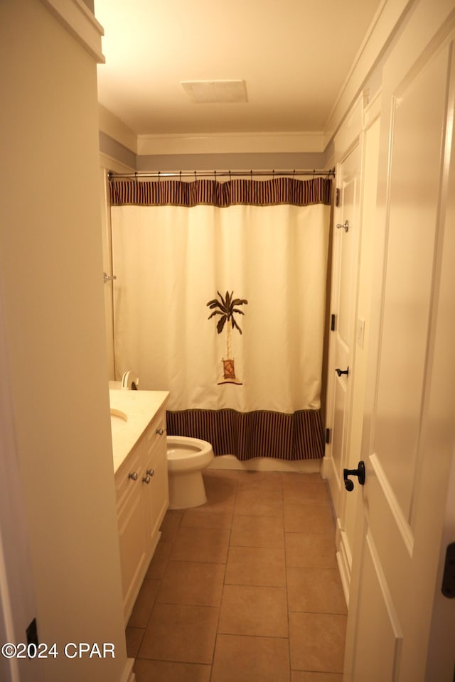 bathroom featuring tile patterned flooring, vanity, walk in shower, and toilet