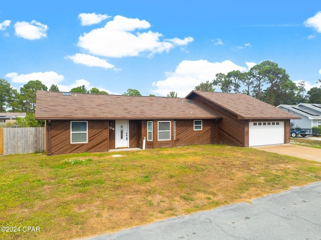 single story home with a front yard and a garage