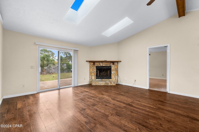 unfurnished living room featuring vaulted ceiling with beams, hardwood / wood-style flooring, and a fireplace