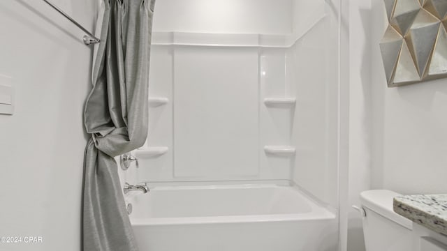 bathroom with toilet and shower / bath combination