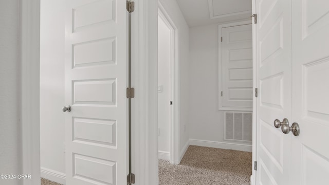 hallway featuring light carpet