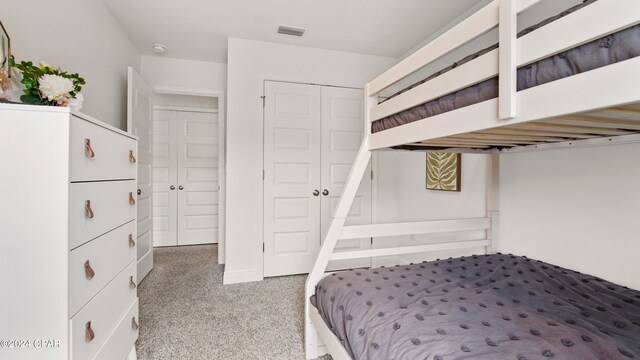 bedroom with carpet flooring and a closet