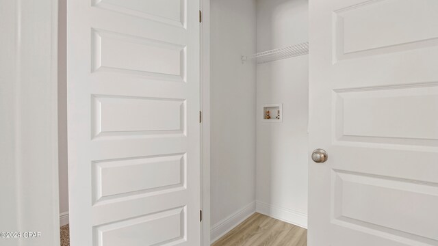 laundry room featuring washer hookup and light hardwood / wood-style floors