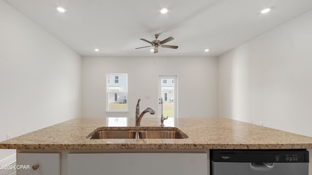 kitchen with stainless steel dishwasher, ceiling fan, a center island with sink, and sink