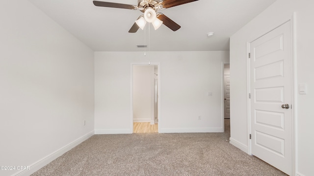 unfurnished bedroom featuring light colored carpet and ceiling fan